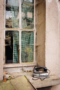 Broken window of abandoned building