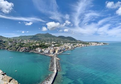 High angle view of sea and cityscape against sky