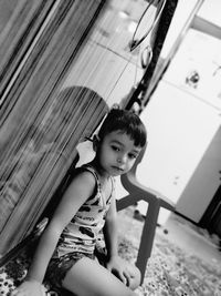 Cute boy sitting on floor at home