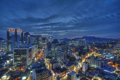 High angle view of illuminated cityscape against sky at night