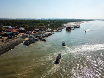High angle view of boats moored in sea against sky