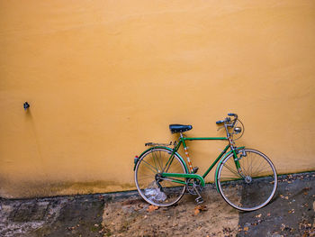 Bicycle leaning against wall