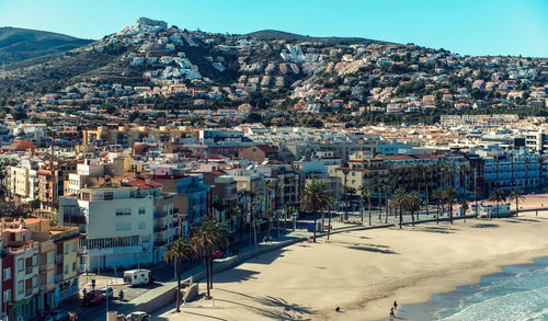 Buildings by beach seen from castillo de peniscola