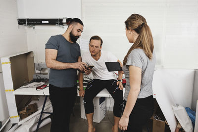 Engineers checking workout app in technologies at office