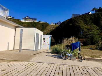 Bicycle outside building against blue sky