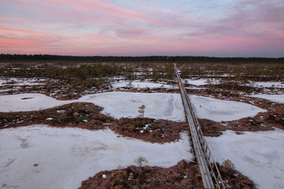 Scenic view of frozen river against sky during winter