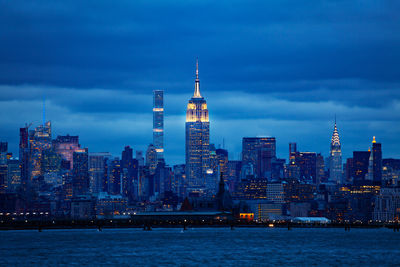 Illuminated buildings in city at dusk