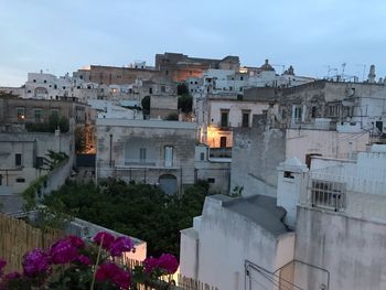 Buildings in city against sky at dusk