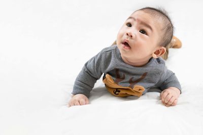 Portrait of cute baby against white background