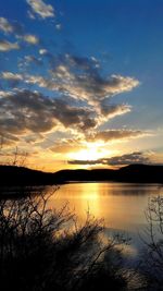 Scenic view of lake against orange sky
