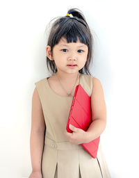 Portrait of a girl standing against white background