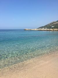 Scenic view of sea against clear blue sky