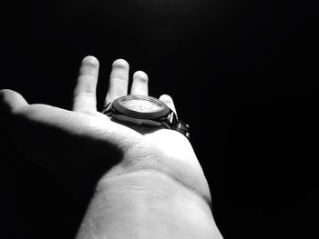 Close-up of hand against black background