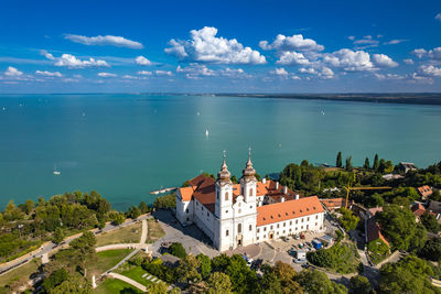 High angle view of townscape by sea against sky