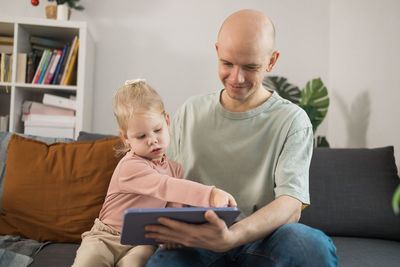 Boy using mobile phone while sitting at home