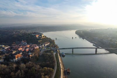 High angle view of city by sea against sky