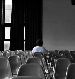 Rear view of a man sitting on chair