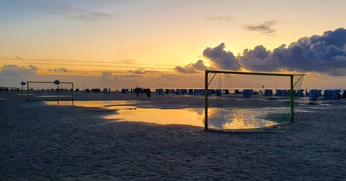 Scenic view of beach against sky during sunset