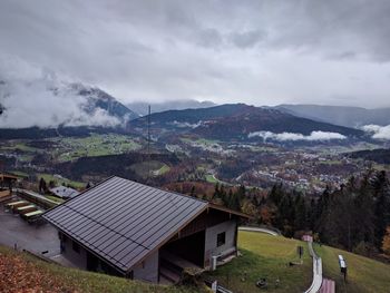 Houses by mountains against sky