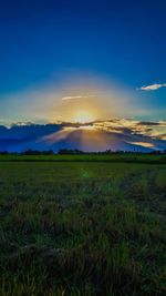 Scenic view of field against sky during sunset