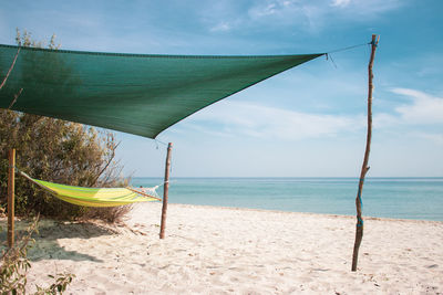 Scenic view of sea with hammock and sunshade. relax on beach.