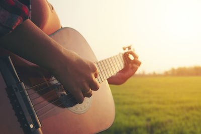 Man playing guitar on field