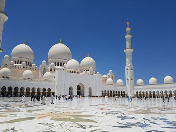 Group of people in temple against clear sky