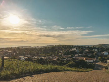 Aerial view of city buildings against sky during sunset