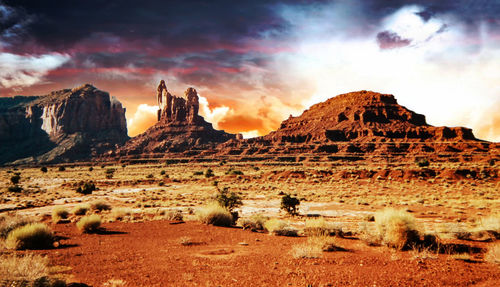 Panoramic view of rocks on landscape against cloudy sky