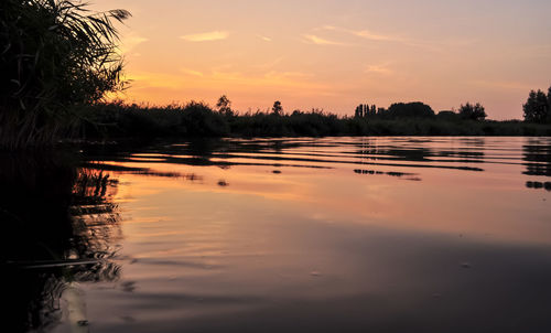 Scenic view of lake against sky during sunset