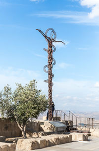 Plant by railing against sky