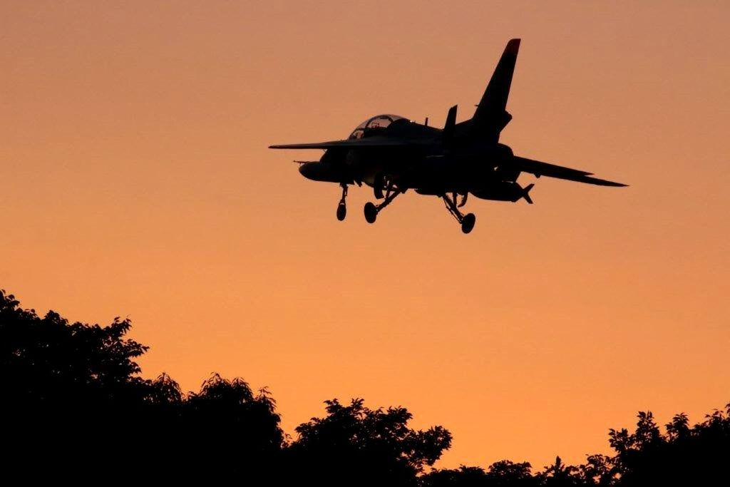 flying, mode of transport, airplane, air vehicle, transportation, mid-air, silhouette, sunset, low angle view, on the move, travel, helicopter, clear sky, sky, tree, motion, orange color, journey, copy space, outdoors