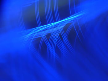 Close-up of illuminated light over blue background