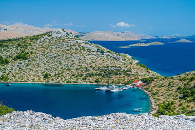 High angle view of townscape by sea against sky