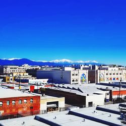 High angle view of townscape against clear blue sky