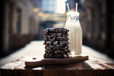 Stack of cookies with milk served on table