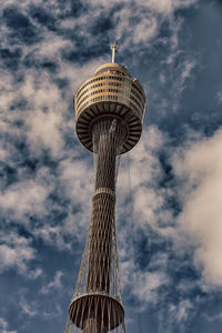 Low angle view of tower against cloudy sky