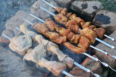 High angle view of meat cooking on fire pit