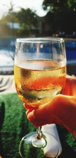 Close-up of hand holding drink in glass