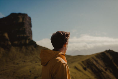 Man standing on landscape against sky