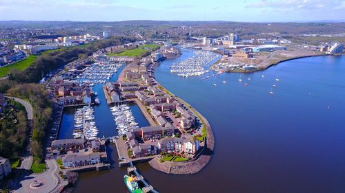 High angle view of river amidst cityscape against sky