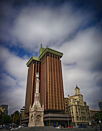 Low angle view of building against cloudy sky