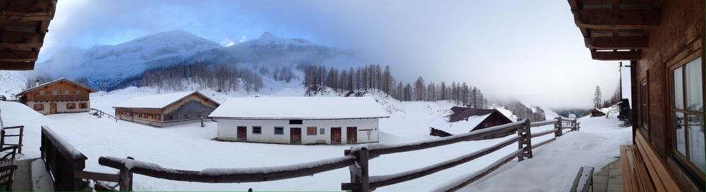 Snow covered houses against sky