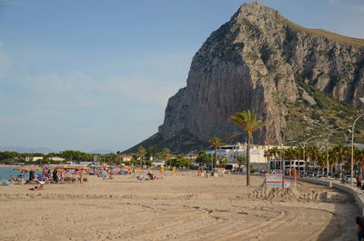 Scenic view of mountain at beach against sky