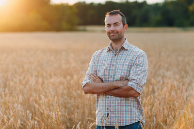 Portrait of smiling man standing in field