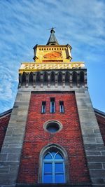 Low angle view of clock tower against sky