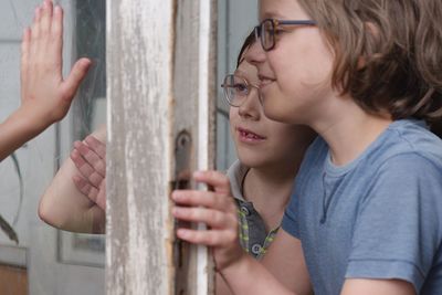 Boys standing by window