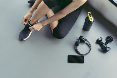 Low section of woman sitting on floor