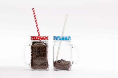 Close-up of drink in glass jar on white background