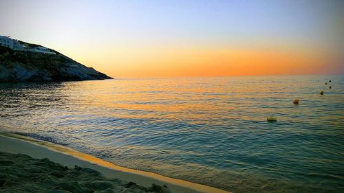 Scenic view of sea against clear sky during sunset